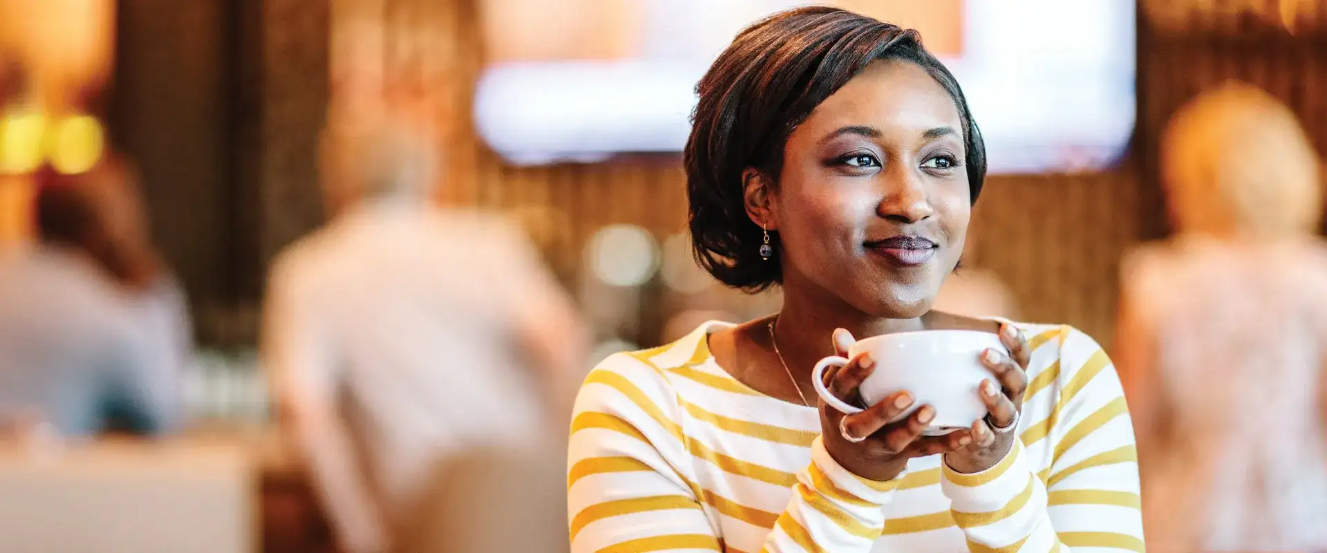 Woman enjoying a cup of coffee.