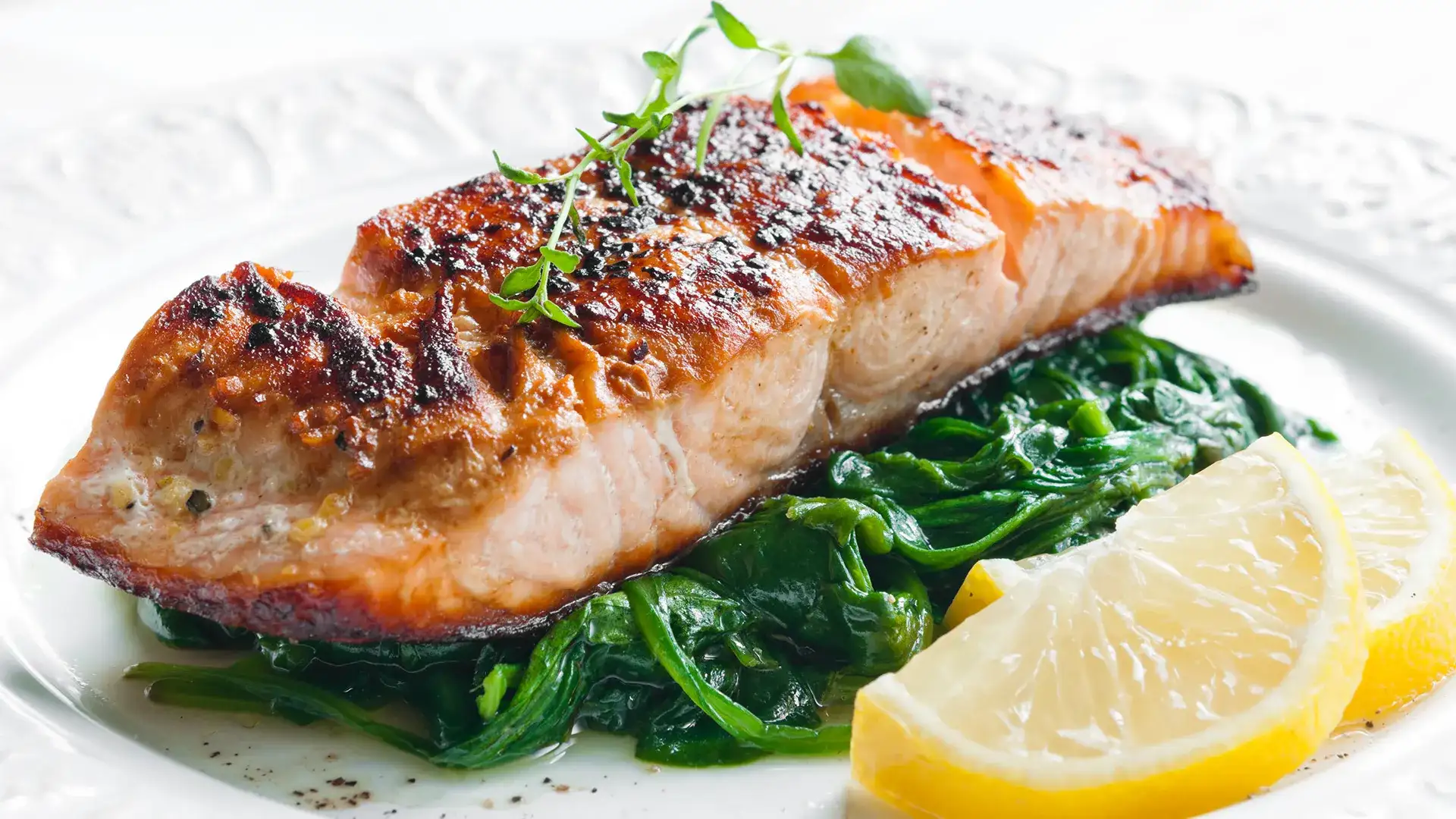 Salmon on a plate over vegetables