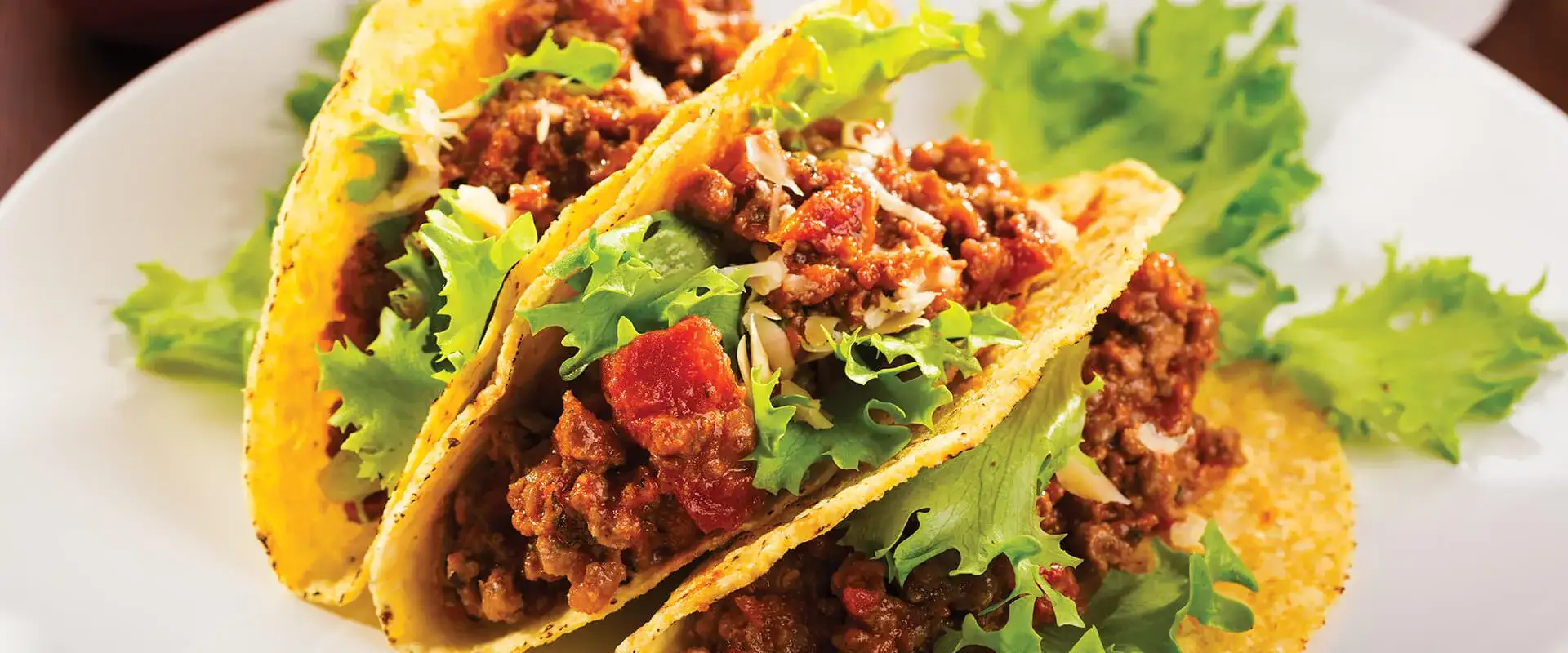 Three tacos on a plate.