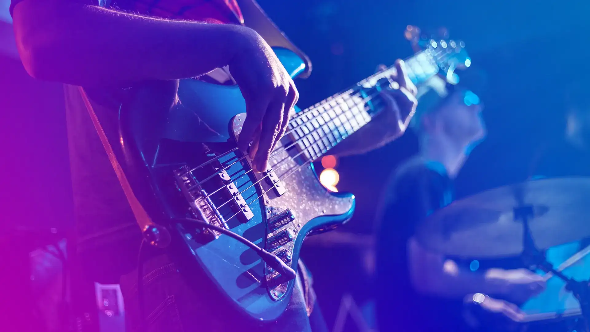 Close-up on person playing a guitar.