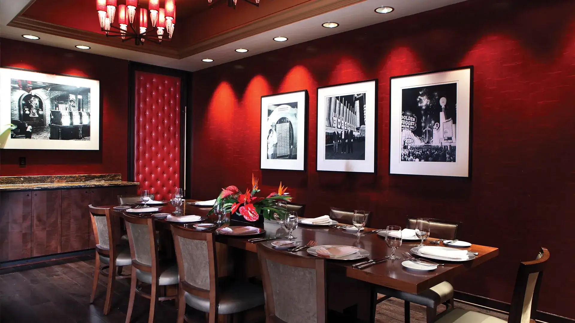 Large party table in room with red, wood, and black motif.