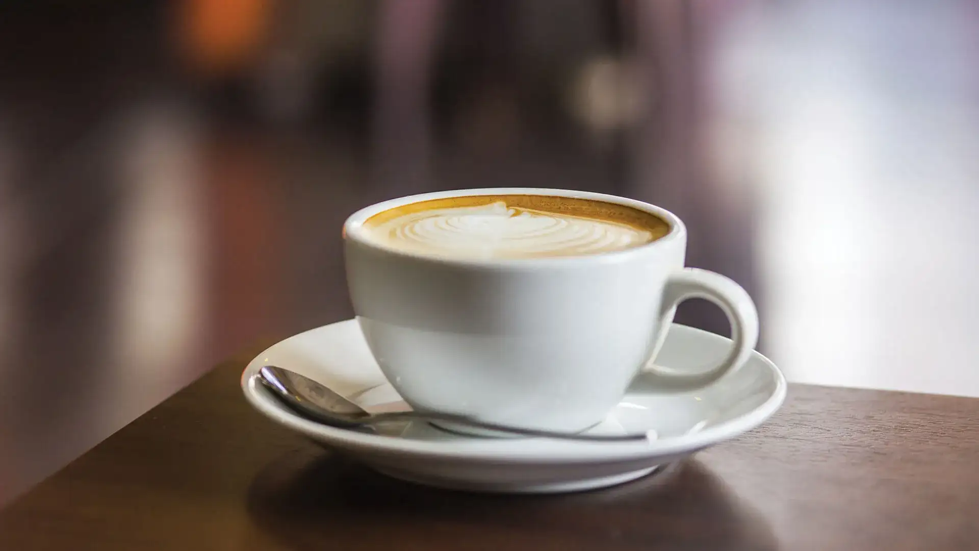 Cup of coffee on a saucer on a table.