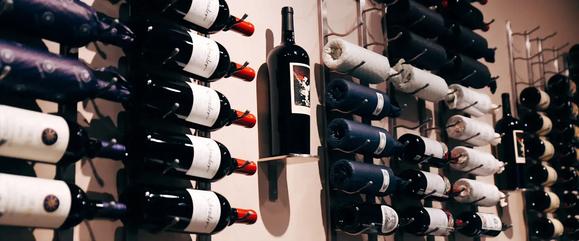 Wine bottles on displayed on a wall.