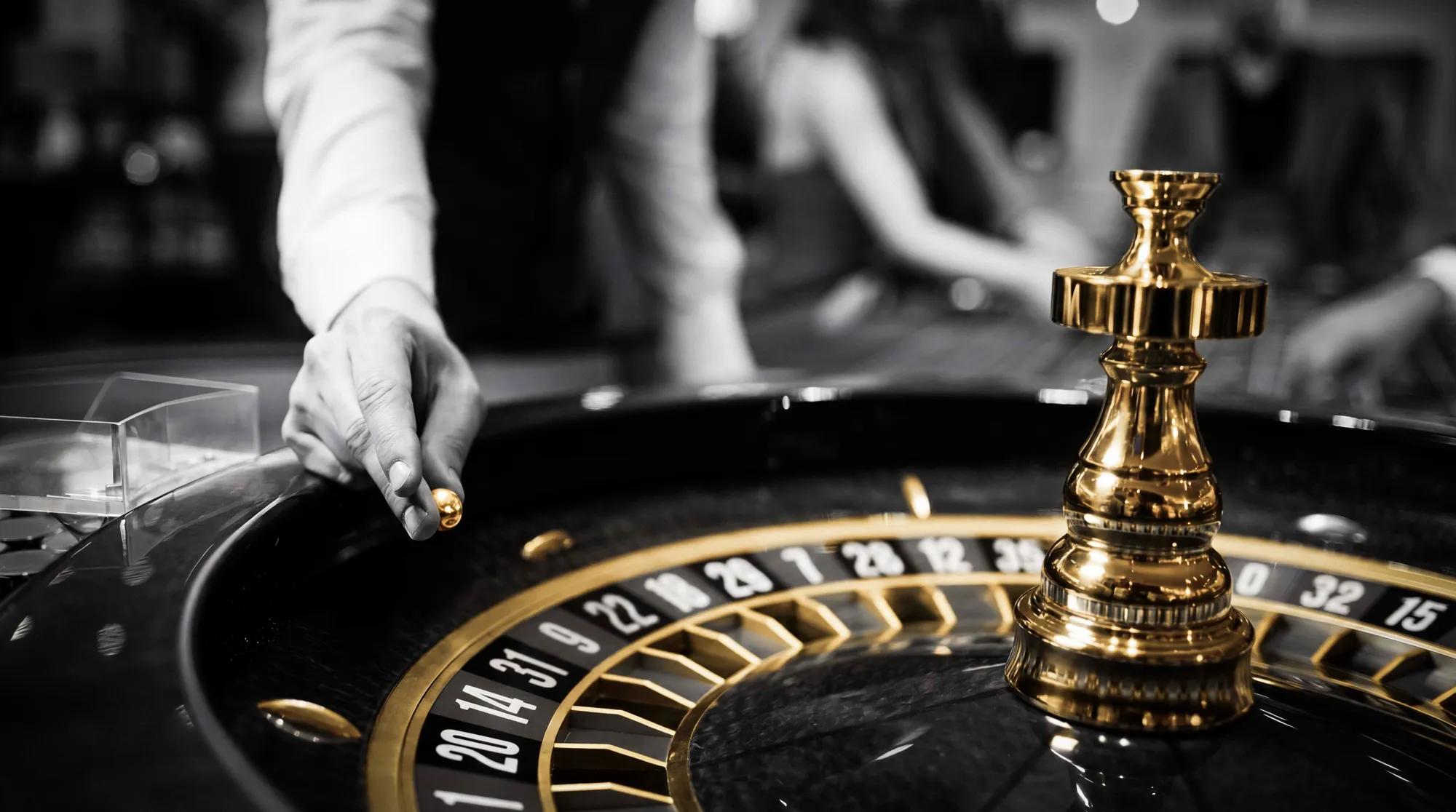 Guests playing roulette at a Caesars casino table, where Olympus members earn Reward Credits faster