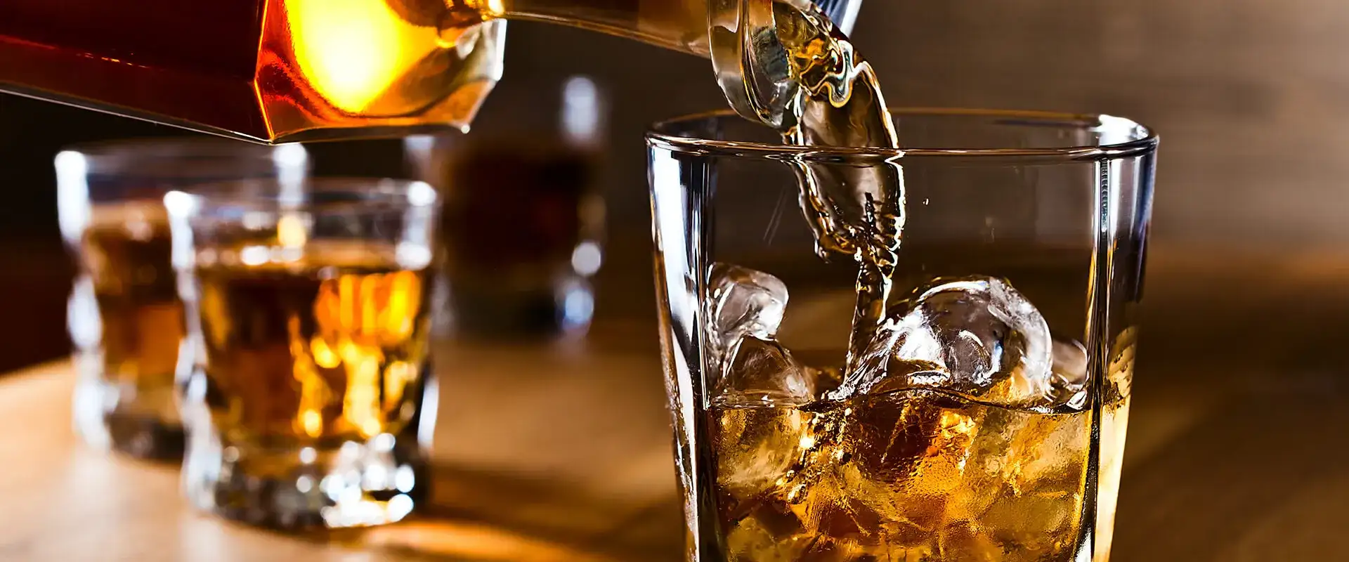 Whiskey Poured Into Glass with Ice