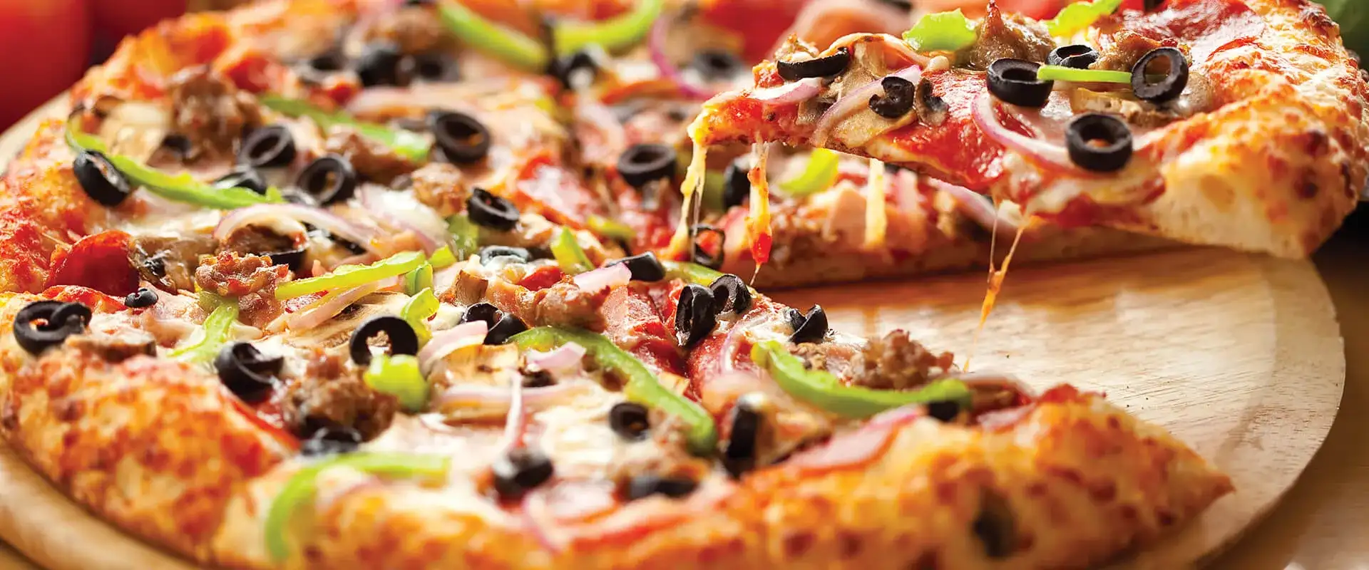 Pizza with pepperoni, olives, and green peppers