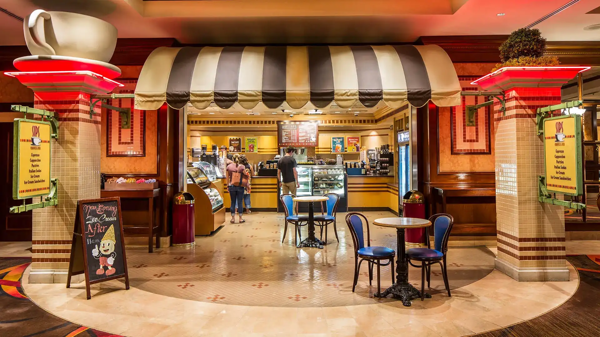 Entrance to Sips Coffee and Tea with seating and counter.