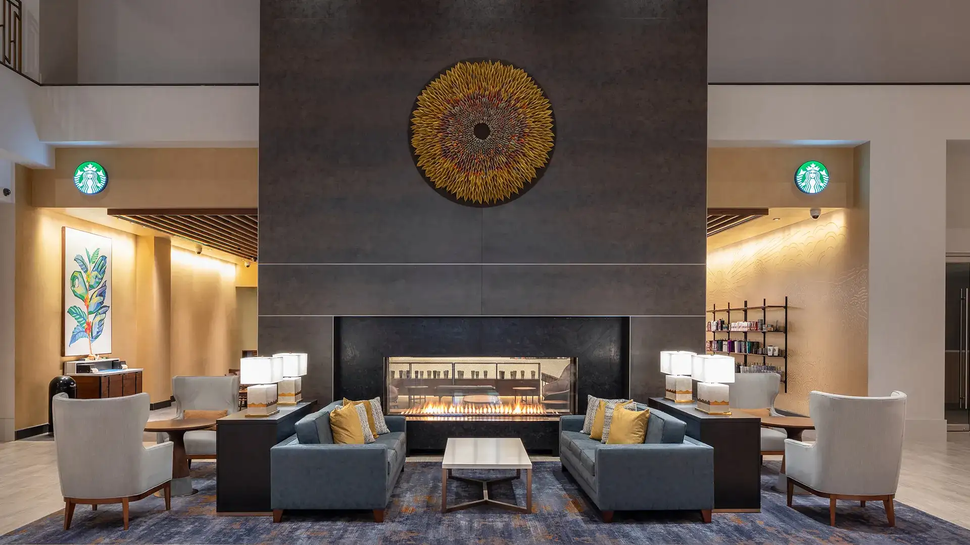 Double-sided fireplace and seating area at Starbucks entrance.