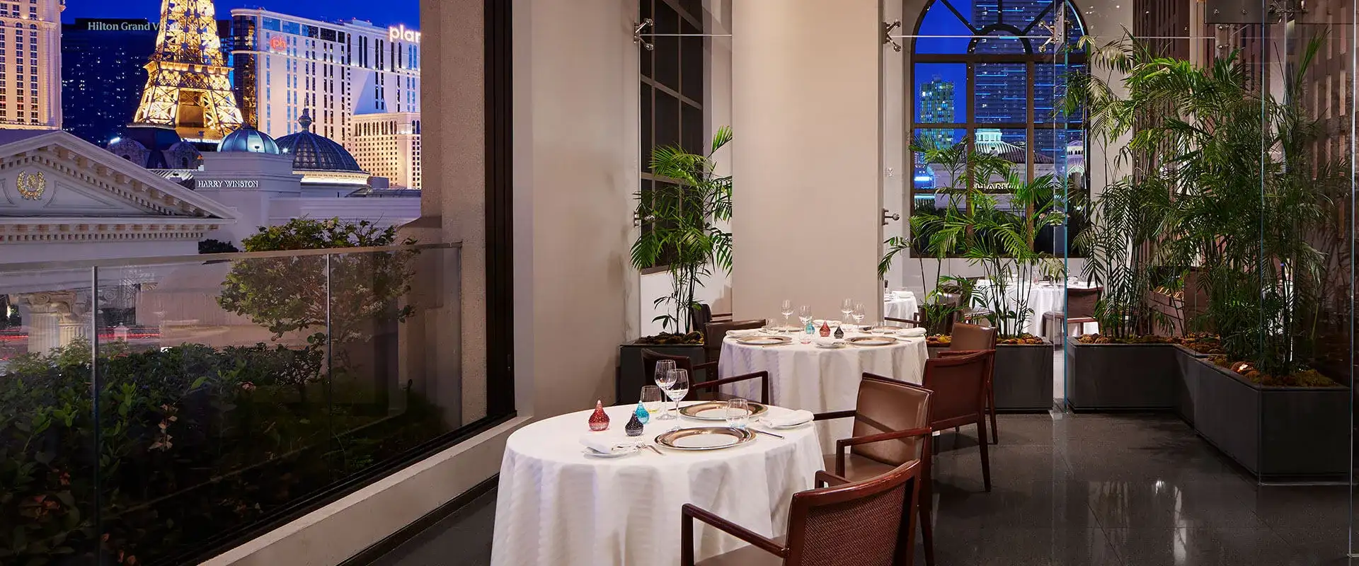 Patio dining area at Guy Savoy with view of the Strip skyline