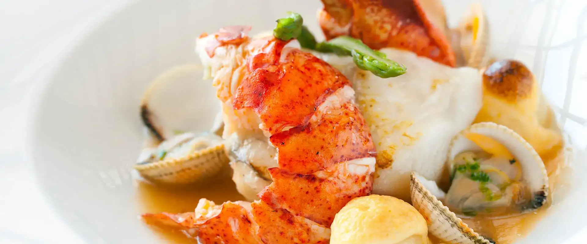 Seafood in a bowl with sauce.
