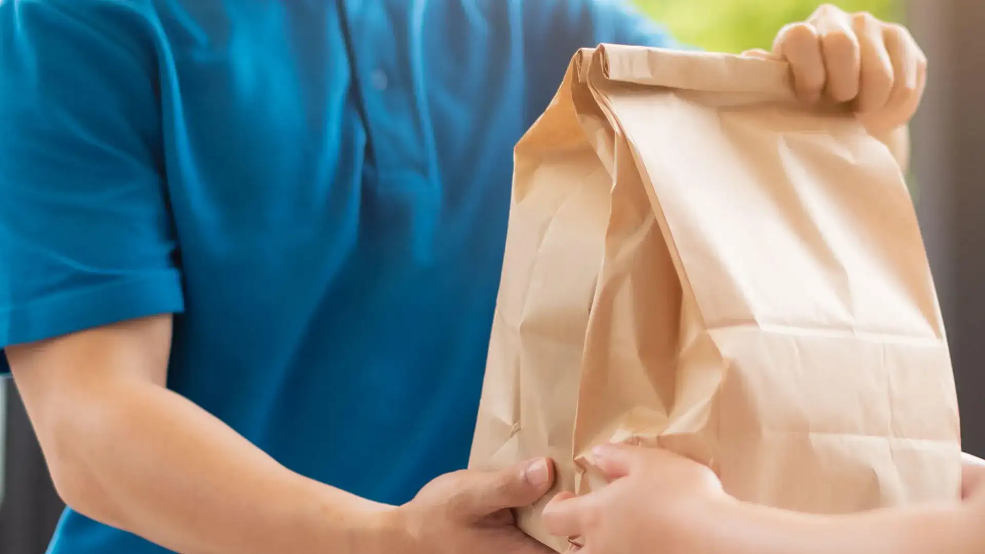 Person delivering takeout bag.