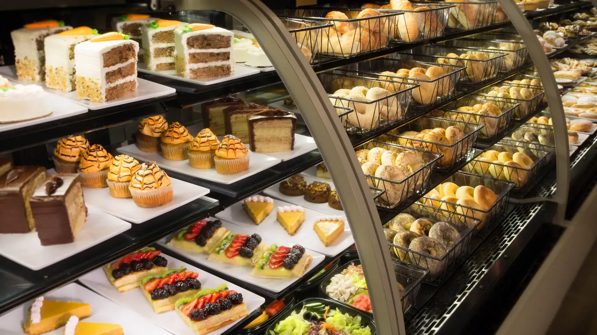 Assortment of pastries and food in a case.