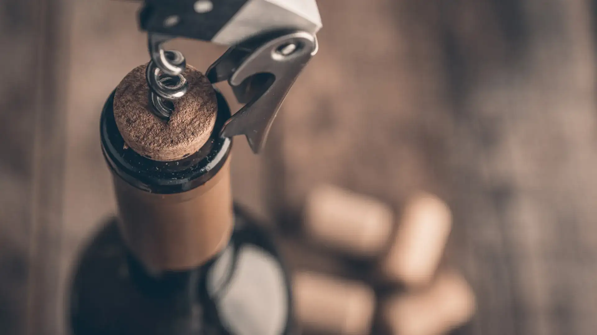 Wine tool pulling cork out of bottle.