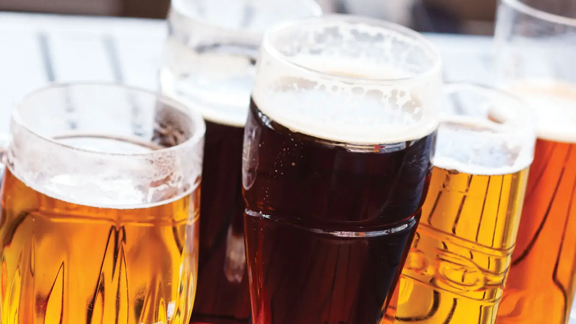 Variety of beer poured in glasses.