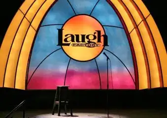 Image of a colorful arch background with the Laugh Factory logo and a silhouette of a microphone