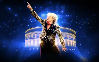 Rod Stewart posing in front of the Caesars Palace Colosseum