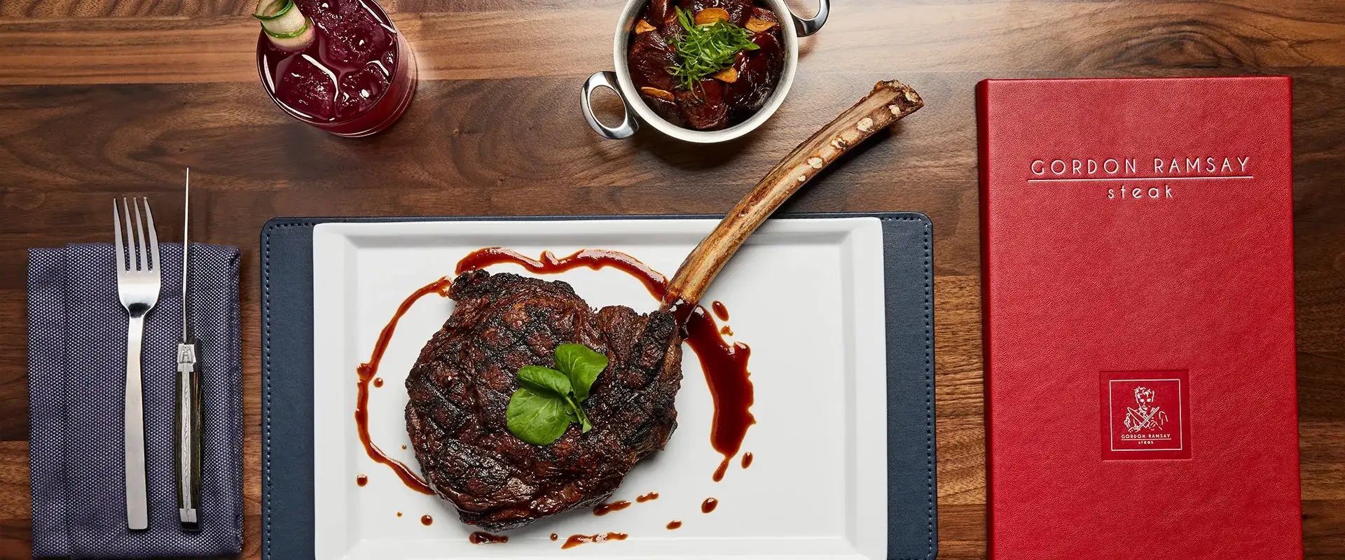 Royal long-bone ribeye chop, mushrooms, and cocktail with red Gordon Ramsay Steak menu.
