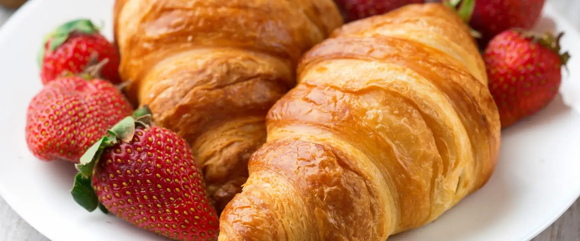 Croissant with fresh strawberries.