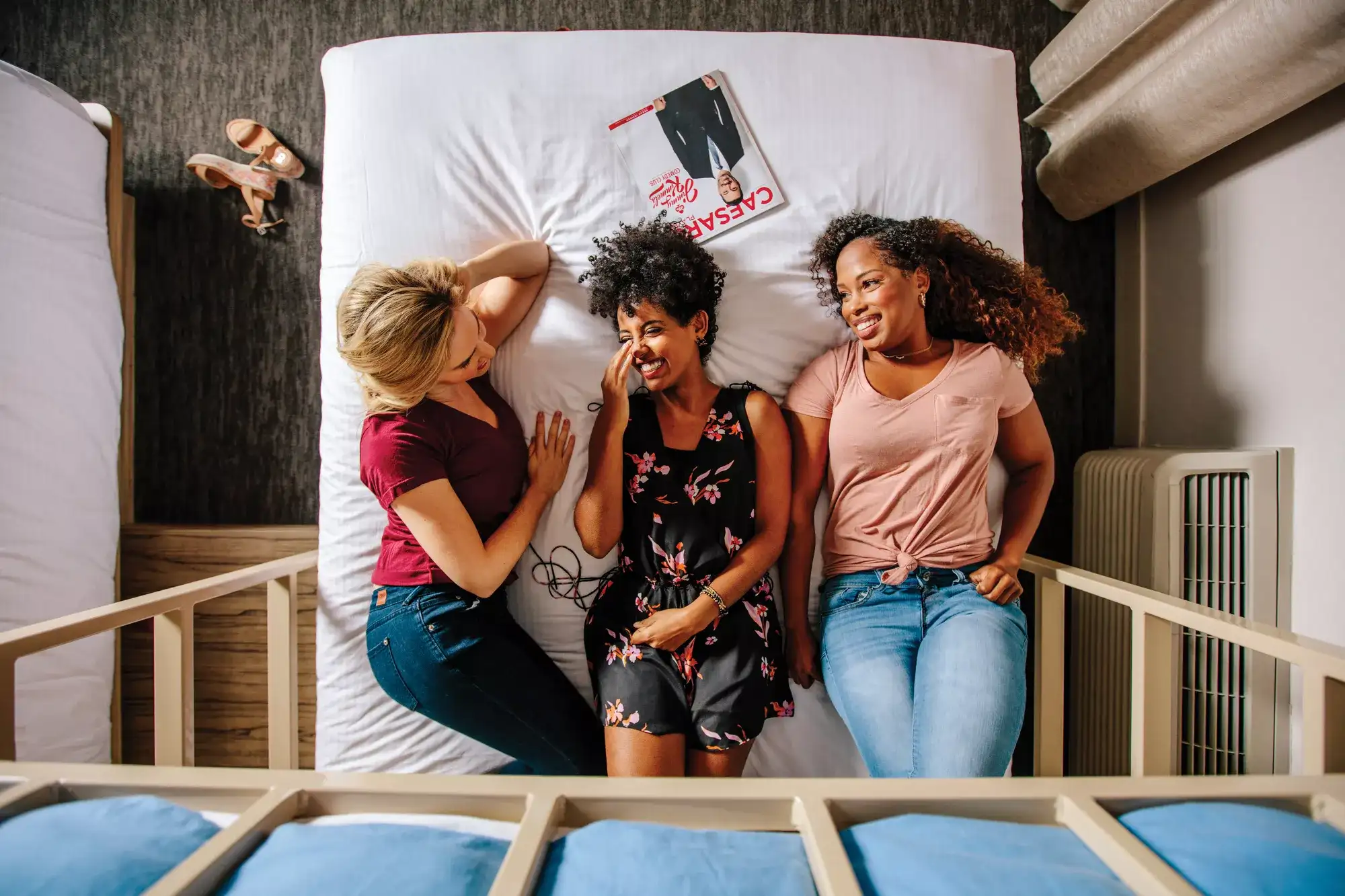 Guests relaxing together in The LINQ Hotel Las Vegas bunk bed suite,  an overhead view showcasing the social room layout ideal for  group travel and girls getaway weekends on the Strip