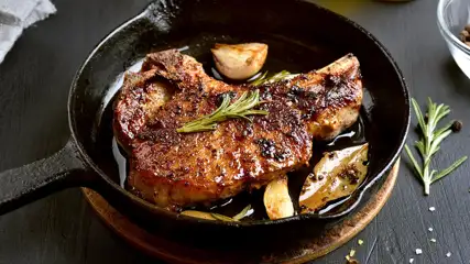 Steak with rosemary in an iron skillet