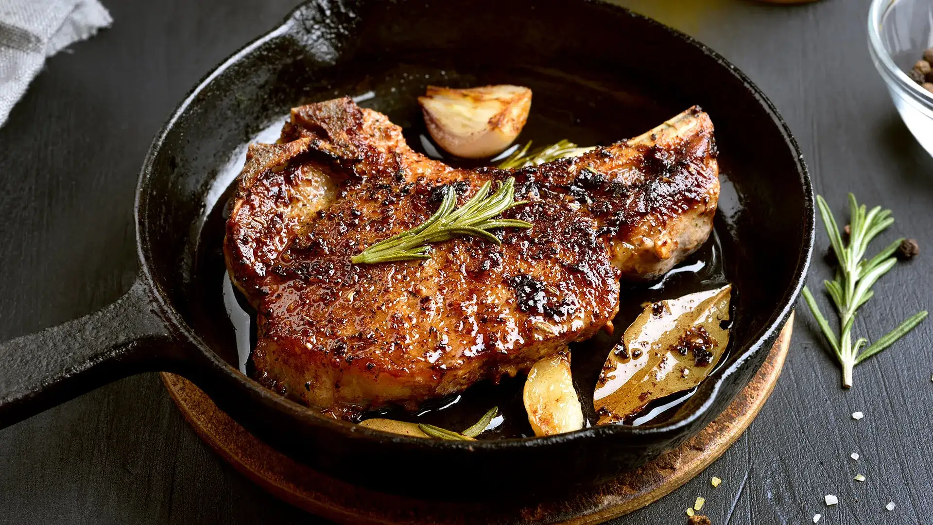 Steak with rosemary in an iron skillet