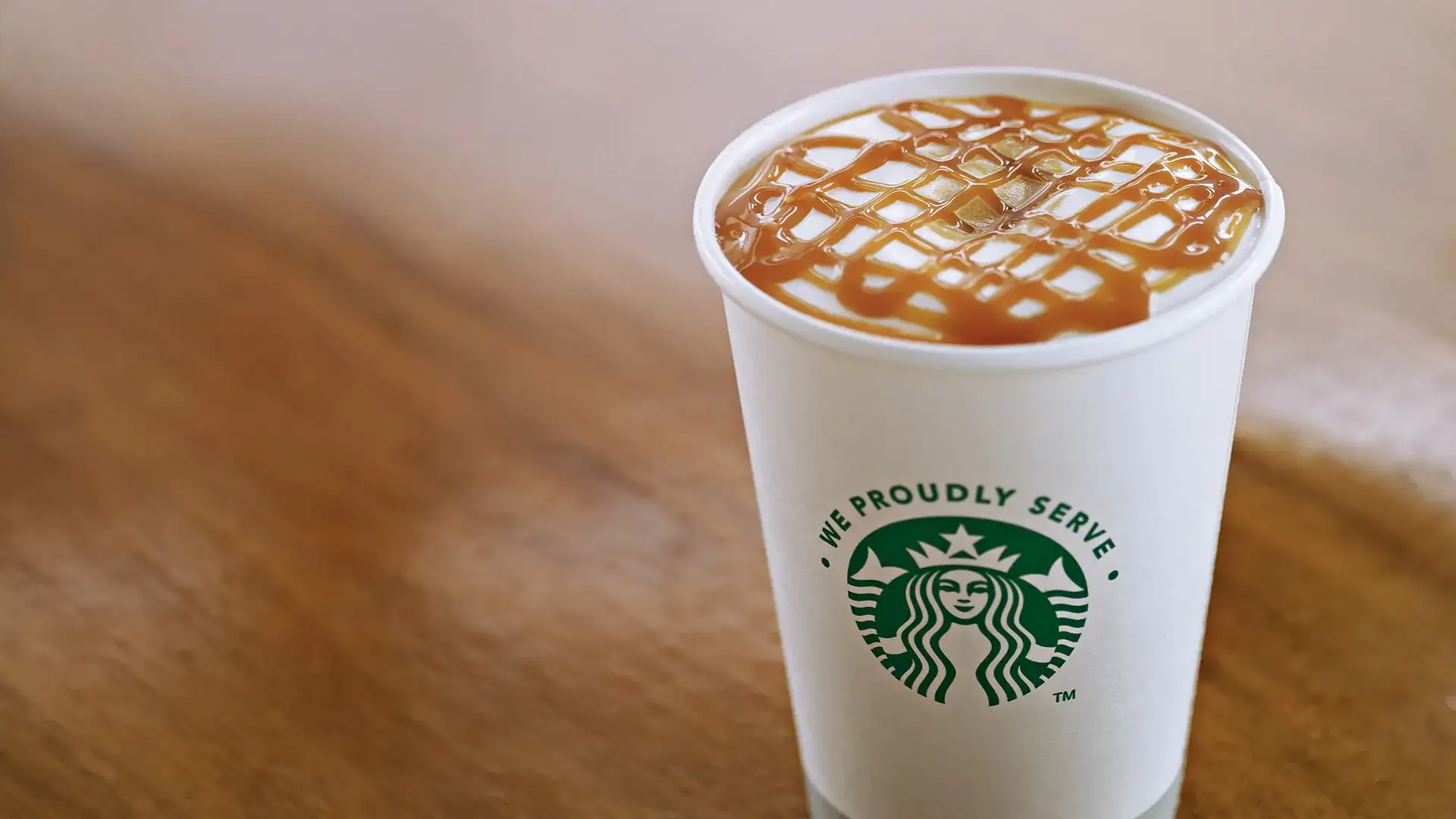 Starbucks to-go drink with caramel topping.