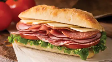 Cold Cut Sadwich with tomatoes in the background