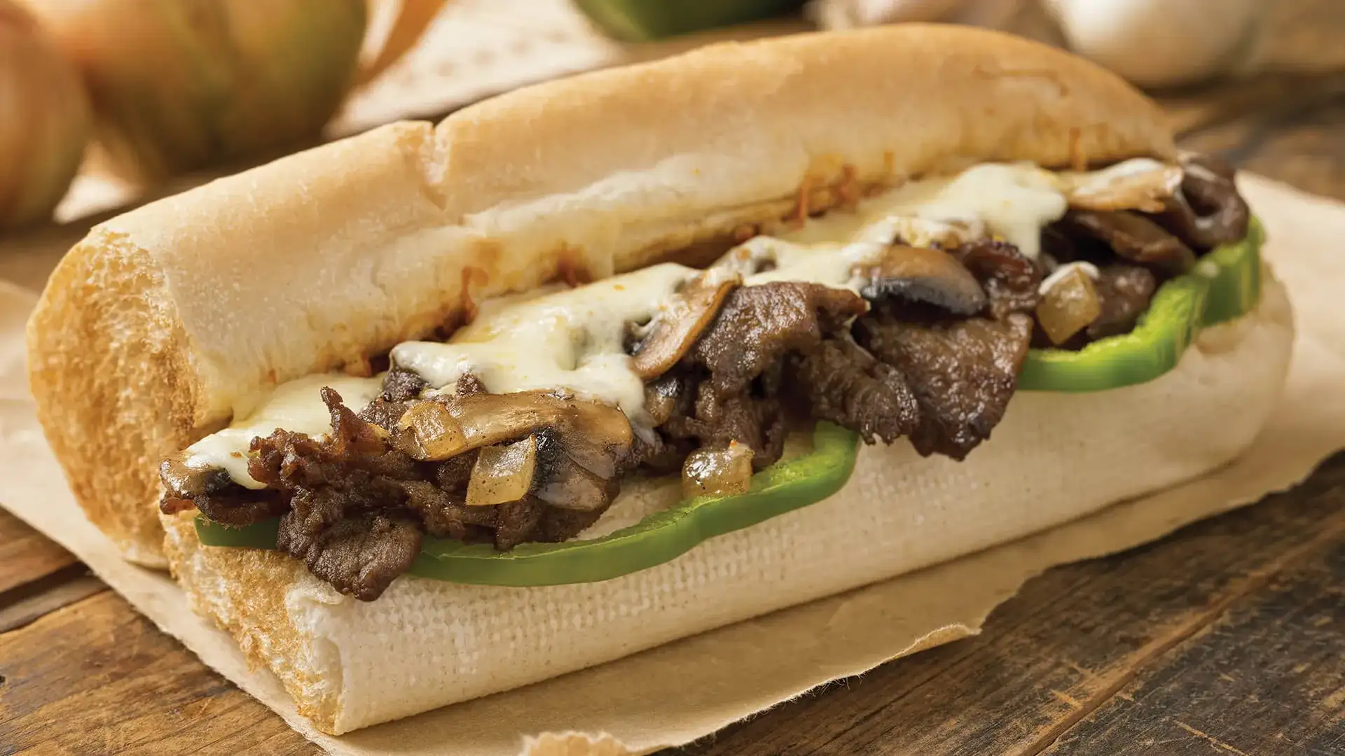 Cheesesteak sandwich on a wooden table