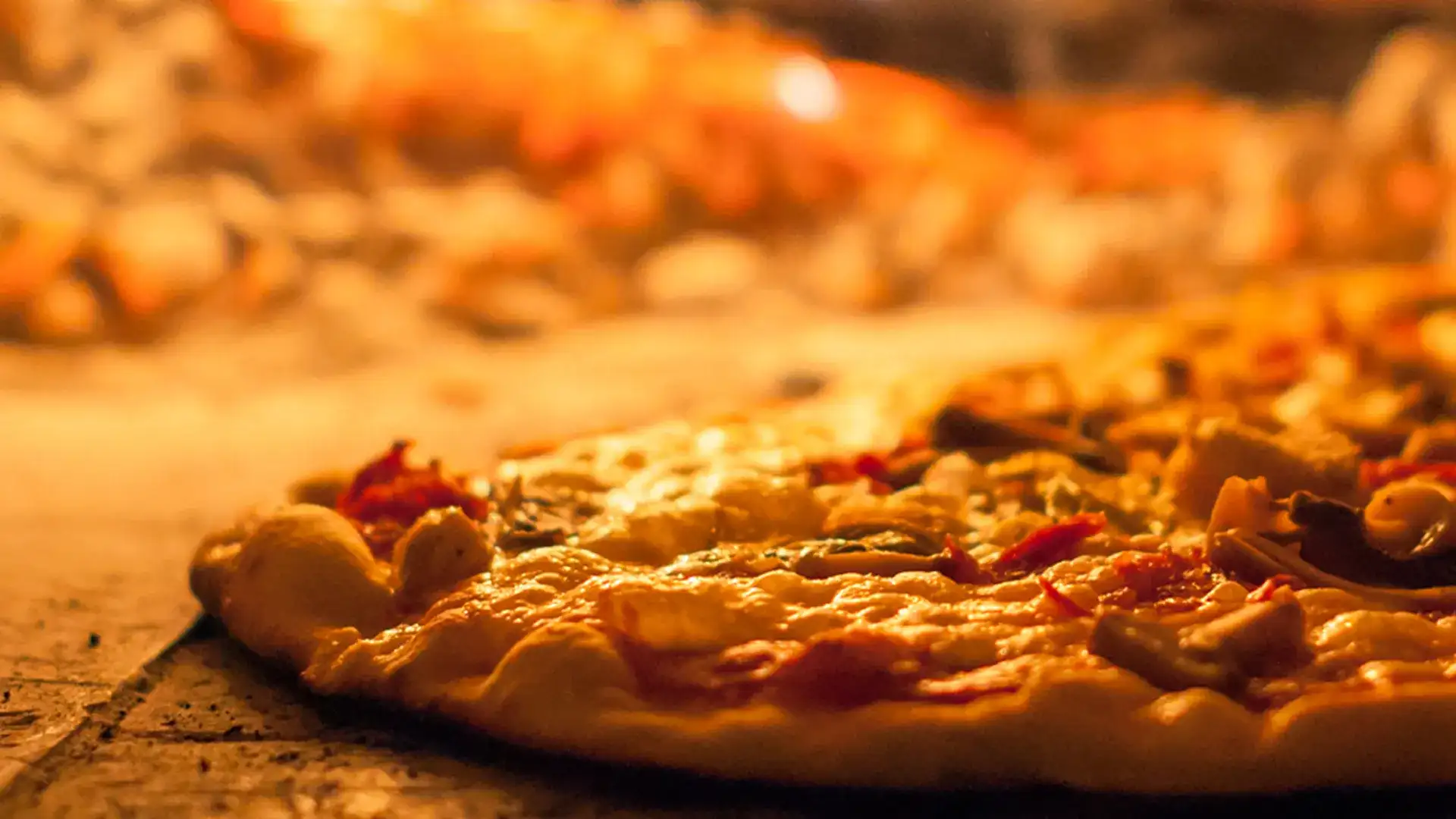 Pizza inside a woodfired oven.