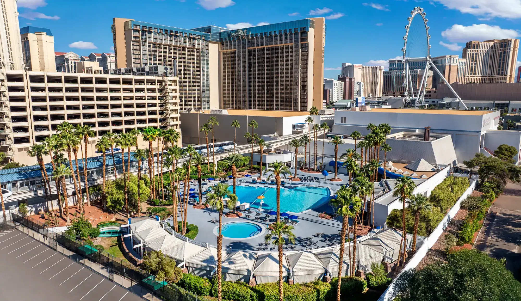 Aerial view of Blu Pool deck with palm trees, cabanas and High Roller views at Horseshoe Las Vegas