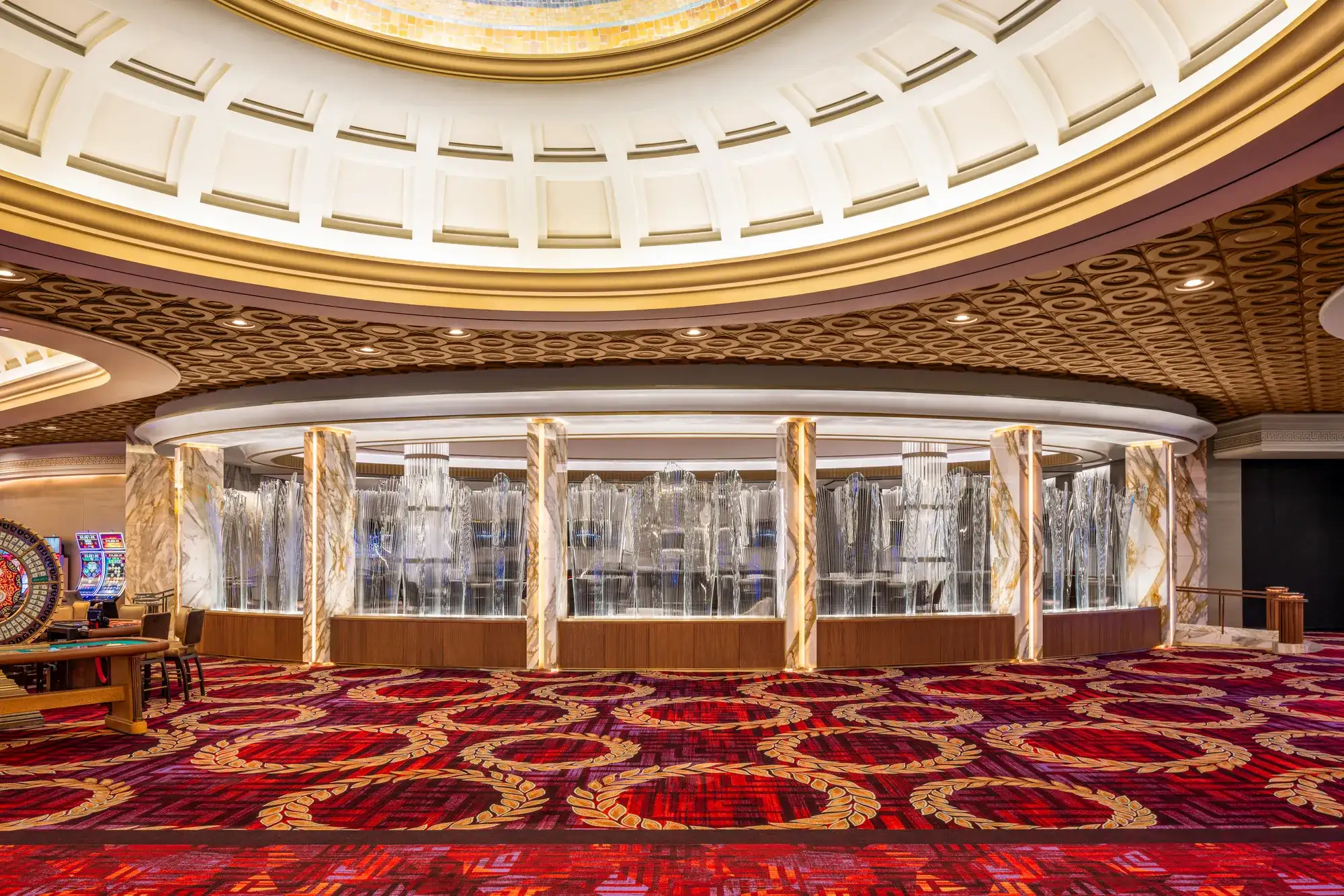 Aureus Lounge at Caesars Palace Las Vegas, a circular high-limit gaming  and cocktail bar featuring marble columns, cascading crystal light  installations, and a Roman-inspired gold coffered dome ceiling on the casino floor