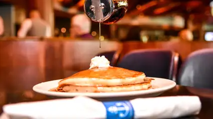 Syrup pouring over pancakes