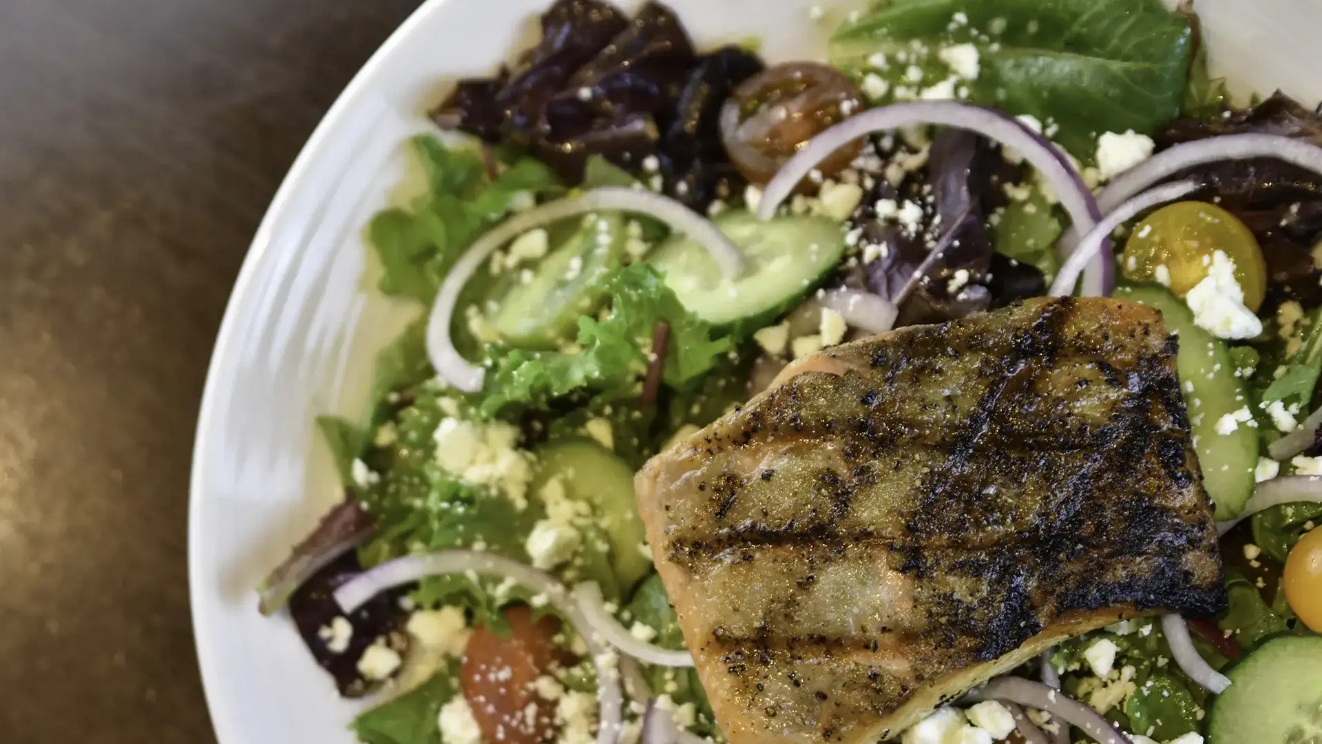 Grilled salmon on Greek salad.