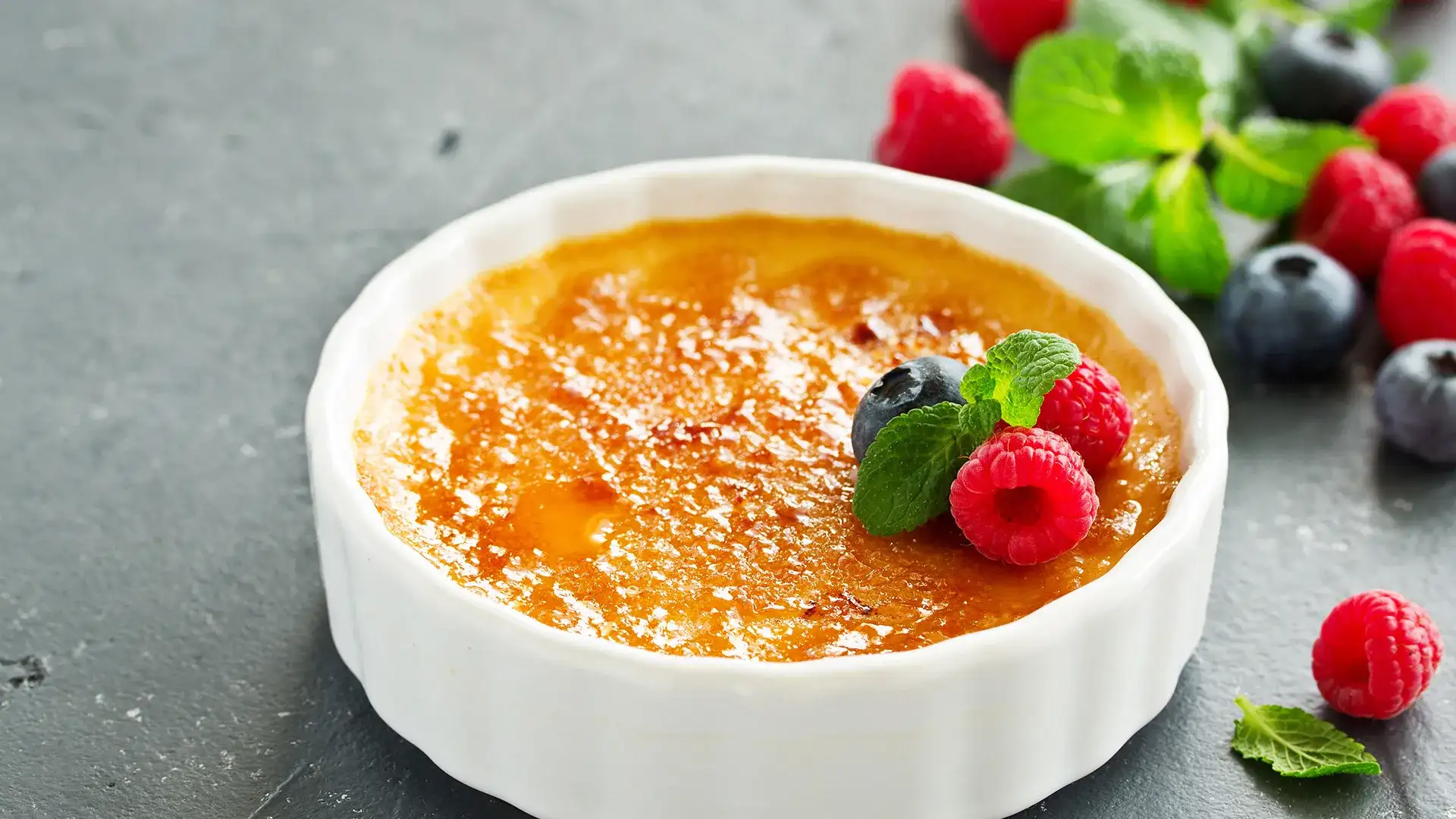 Creme brulee with berry garnish.