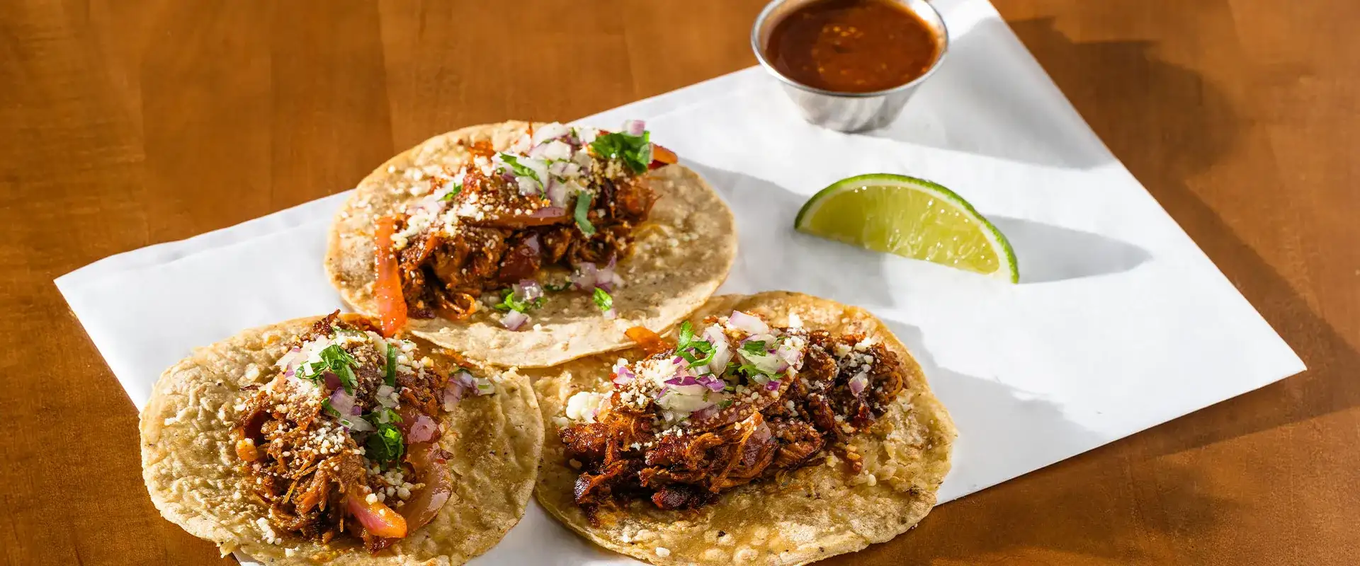 Three tacos with lime at Tortazo by Chef Rick Bayless inside the Celebrity Food Hall at Caesars Palace Las Vegas.