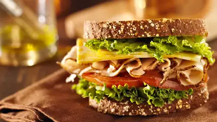 Club sandwich with turkey, tomato, lettuce, and cheese.