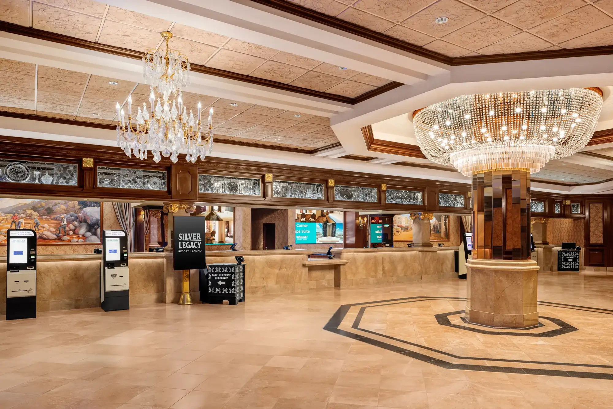 Silver Legacy Resort Hotel & Casino lobby in Reno with check-in desks, self-service kiosks, chandeliers, and marble flooring