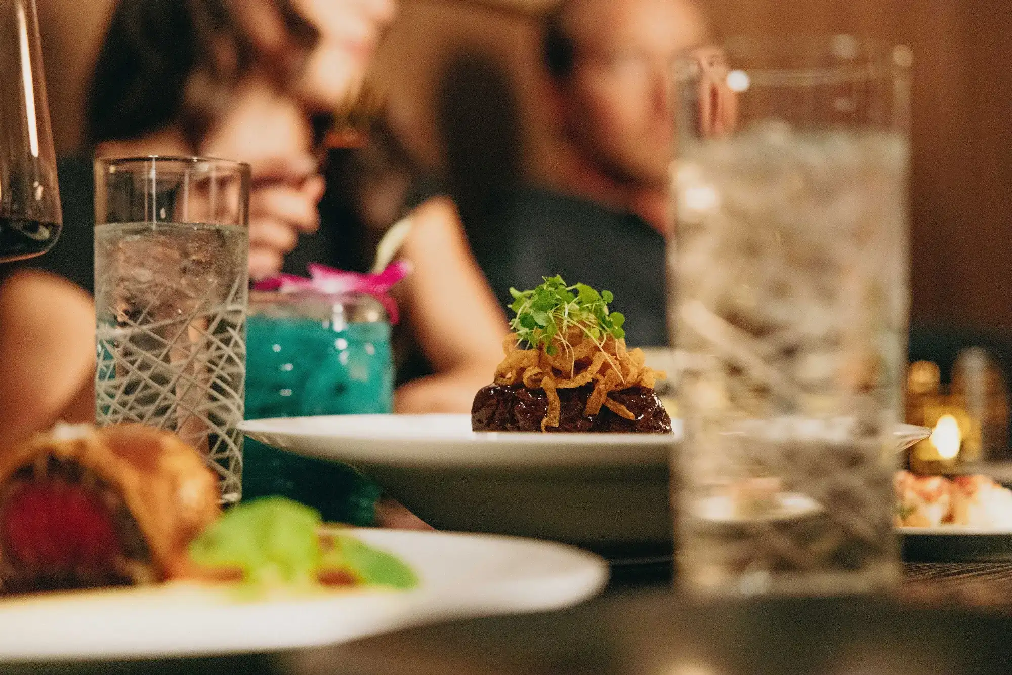 Food and drinks on a table at Gordon Ramsay Hell's Kitchen at Caesars Republic Lake Tahoe.