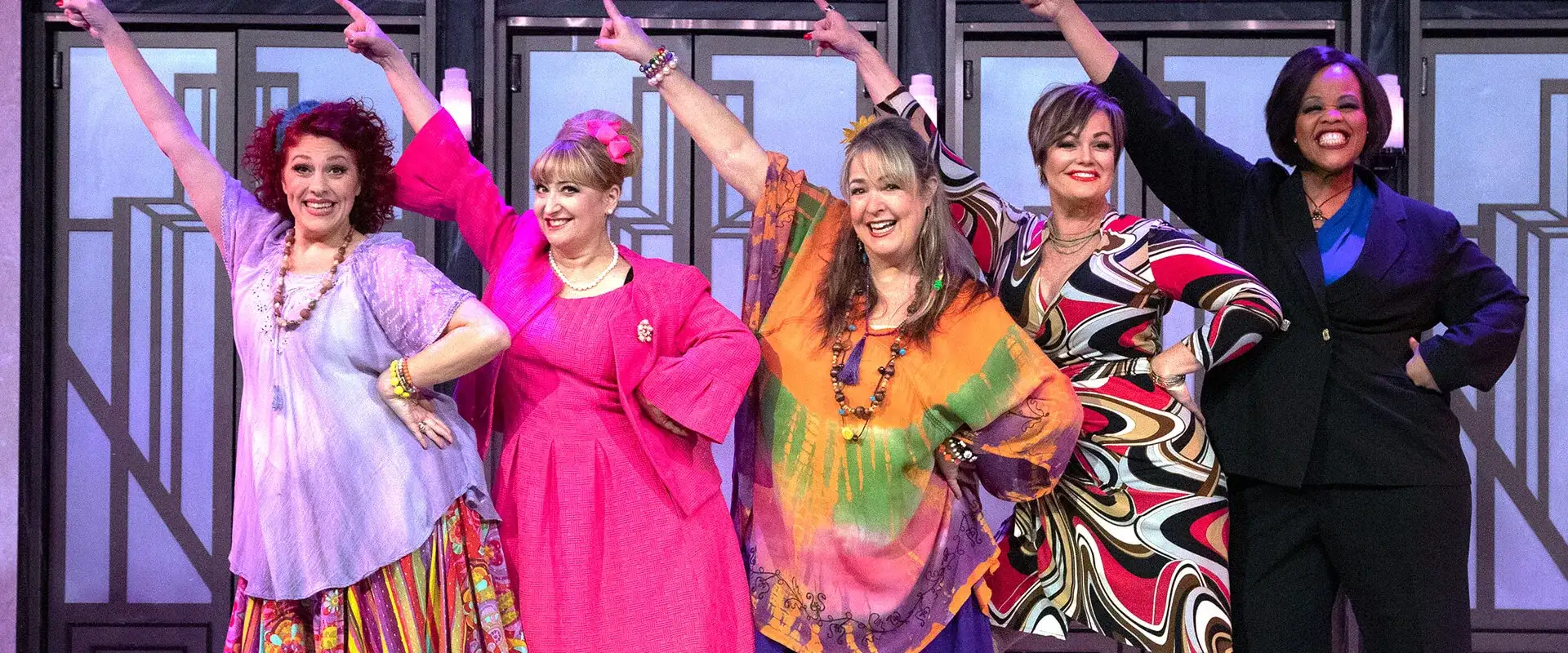 Cast of Menopause the Musical posing on stage.