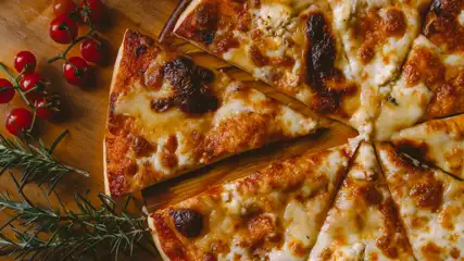 Pizza served by slices on a board
