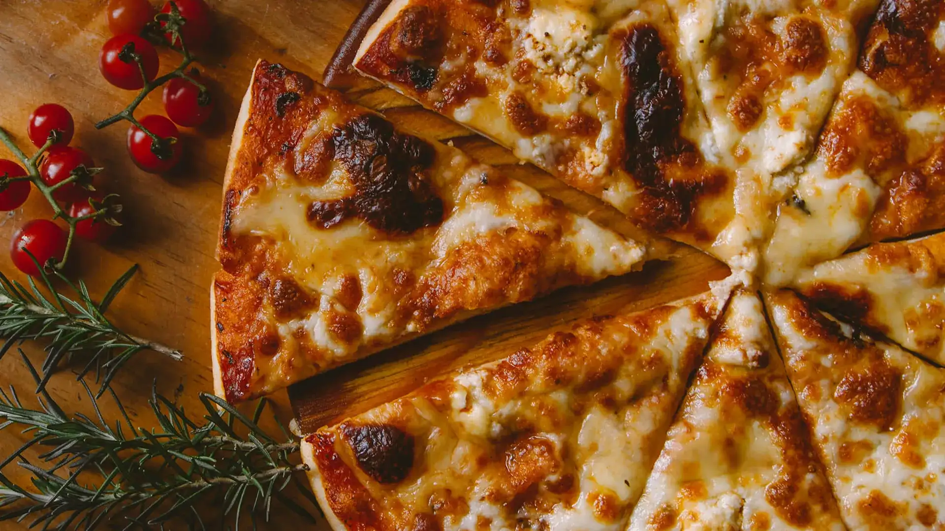 Pizza served by slices on a board