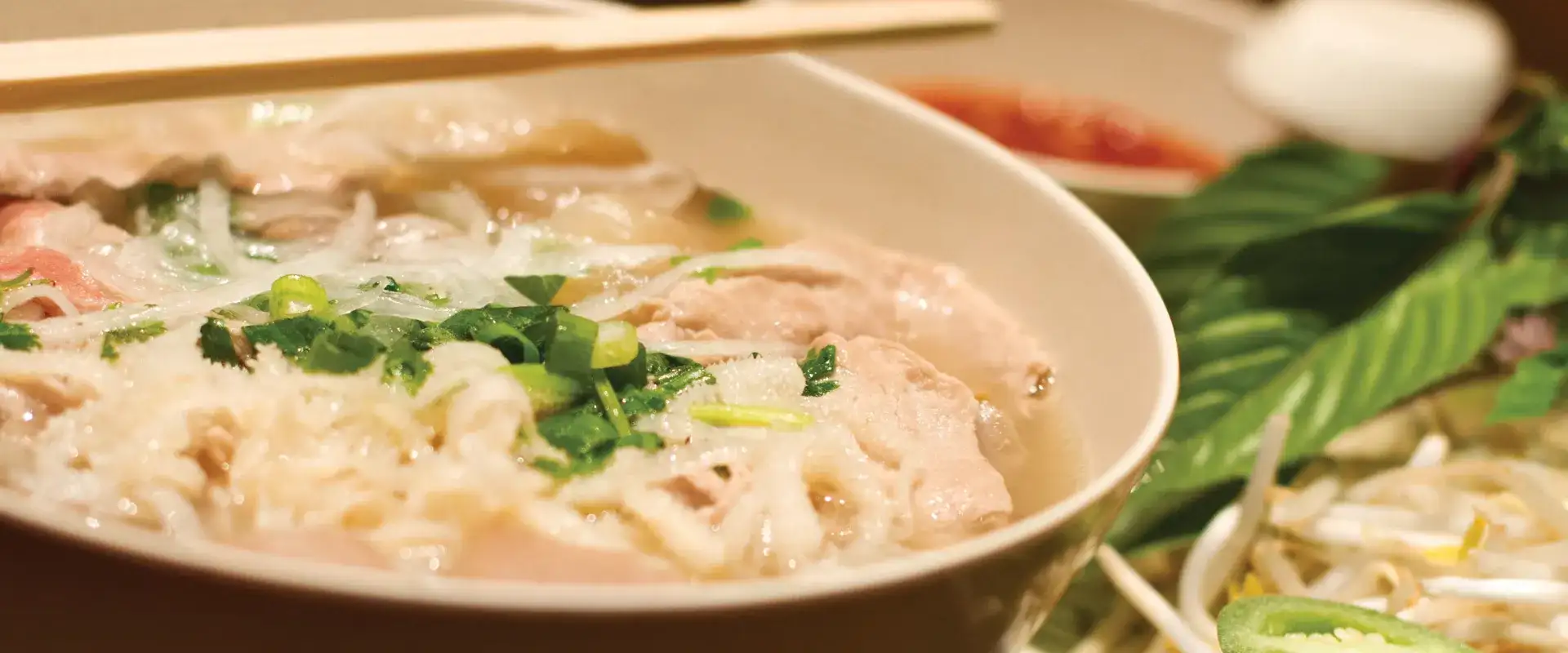 Bowl of Pho with chop sticks.