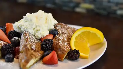 French toast with fruit and whipped cream.