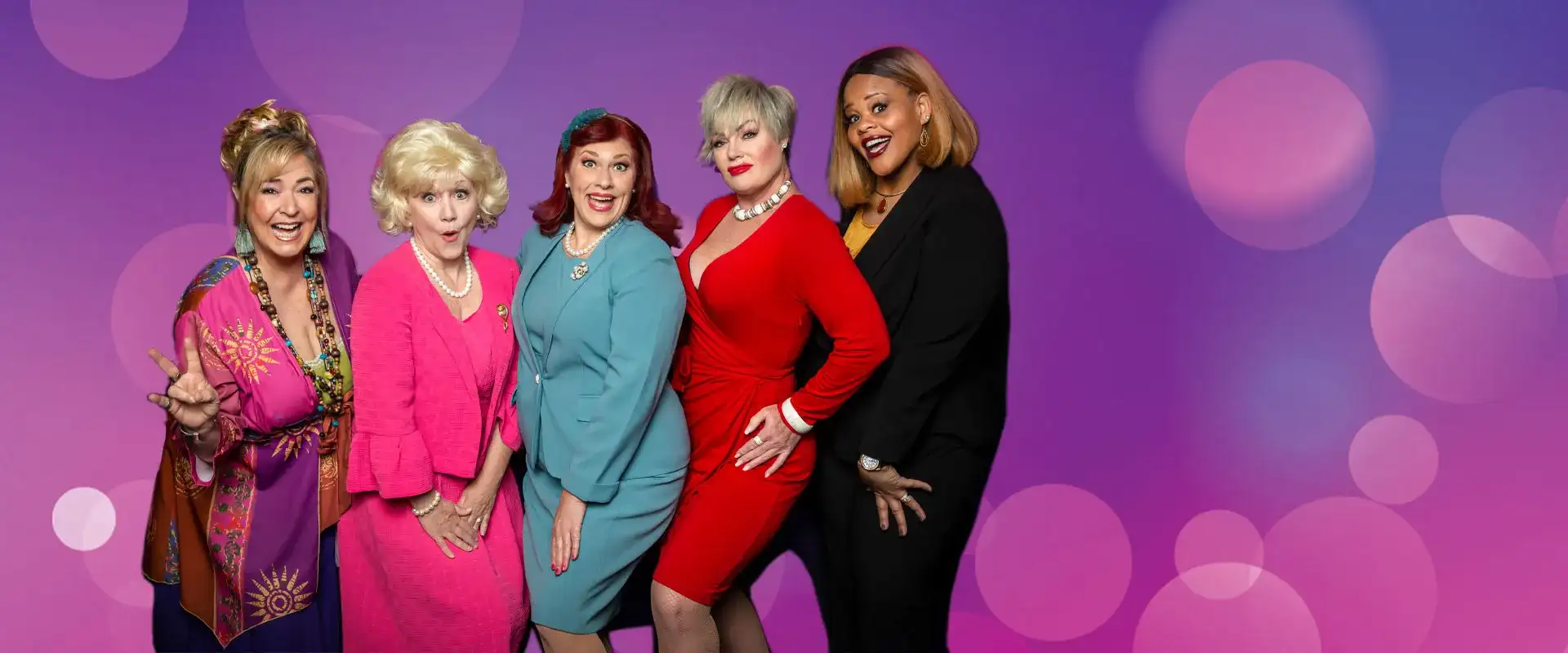 Cast of Menopause the Musical posing in front of a purple background