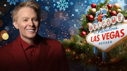 Clay Aiken against a snowy Las Vegas sign.