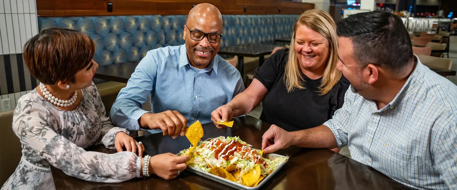 Friends eating nachos in The Piazza Food Court at Caesars Southern Indiana