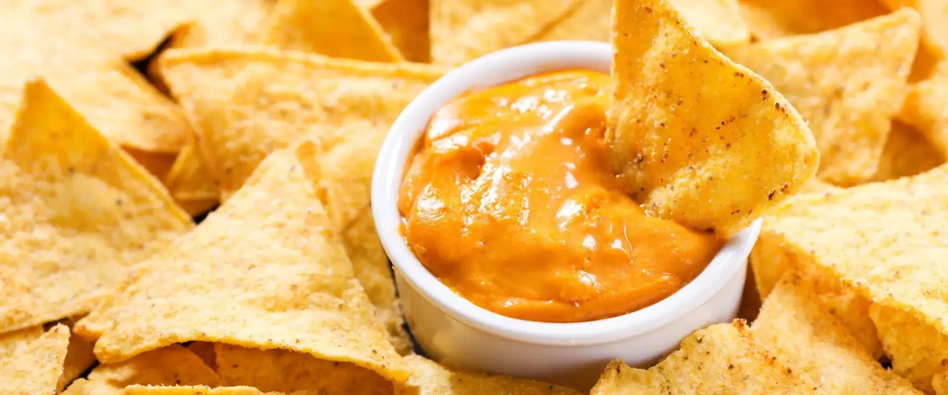 Nacho chips and cheese dip.