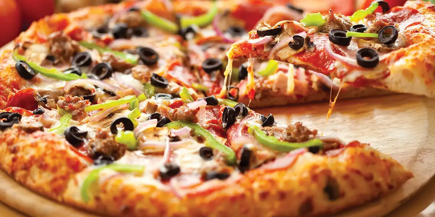 Pizza with pepperoni, olives and green peppers.