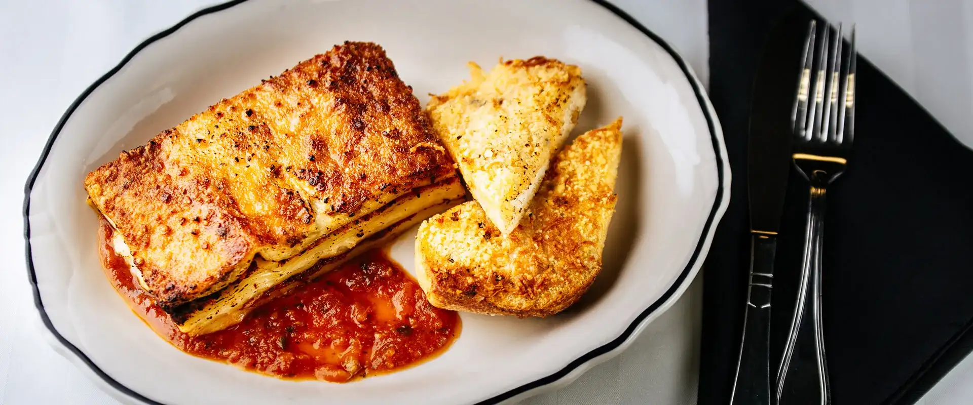 Lasagna with side of garlic bread.