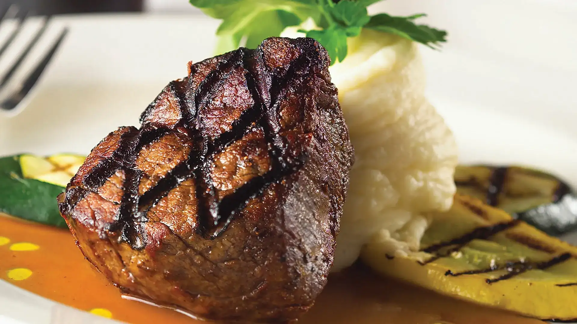 Steak, mashed potatoes, and grilled vegetables.
